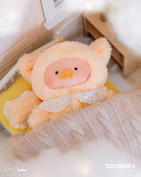 Cream-colored LuLu The Piggy Dreaming Wonderland plush tucked into a miniature bed