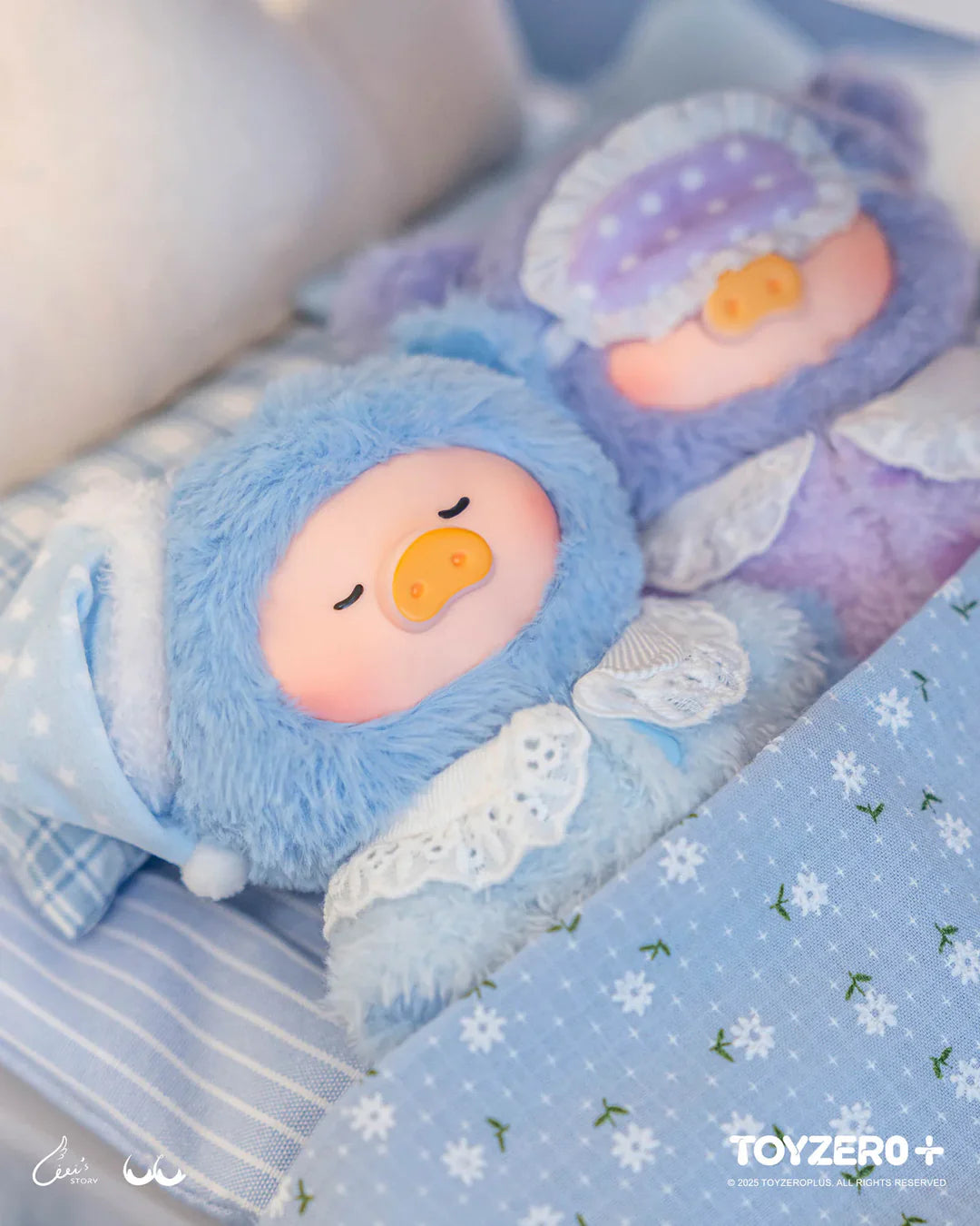 Blue and purple LuLu The Piggy Dreaming Wonderland plush characters sleeping peacefully in bed