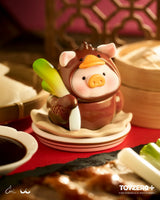 LuLu the Piggy duck costume figure holding bok choy.