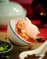 LuLu the Piggy duck costume figure holding bok choy.