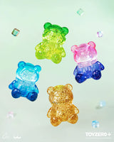 Glitter-filled transparent LuLu The Piggy Teddy Mini figures in blue, pink, green, and gold colors