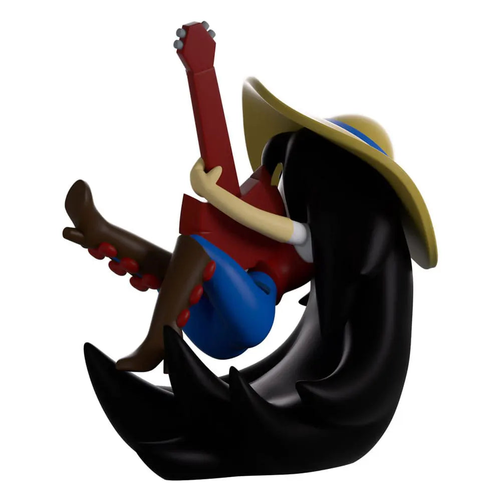 Side view of Marceline Youtooz figure strumming her guitar while floating with her hair flowing.