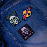 Close-up of colorful Megadeth Vic Rattlehead patch on denim fabric
