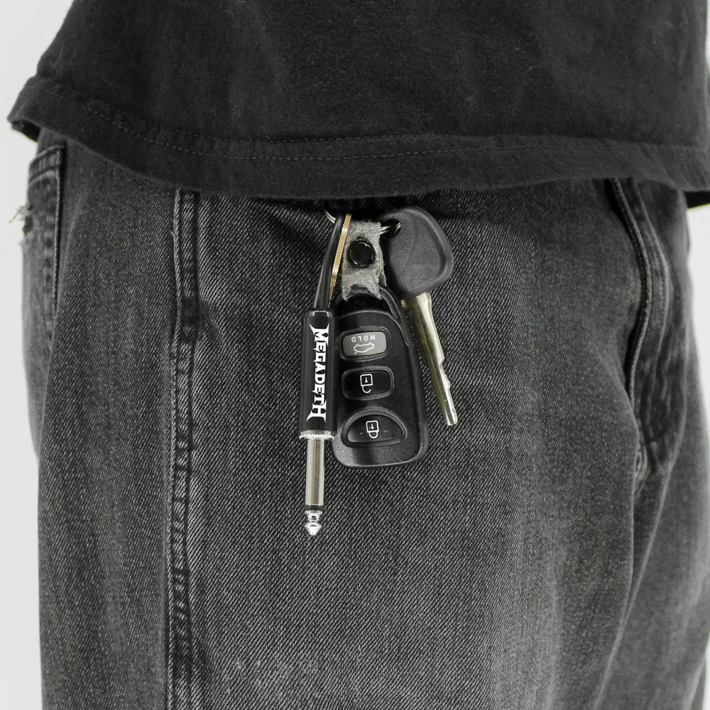 Megadeth plug keychain attached to keys in pocket