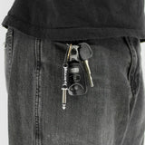 Megadeth plug keychain attached to keys in pocket