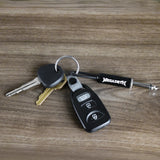 Megadeth guitar plug keychain with keys on wooden surface