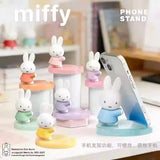 Miffy Pearlescence Phone Stand collection displayed with smartphone showing practical desk usage