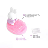 Close-up of pink pearlescent Miffy phone stand base showing decorative beads and support accessories