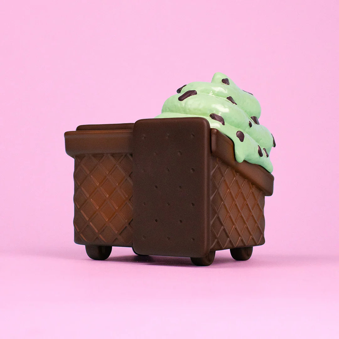 Side view of waffle cone Dumpster Fire figure topped with mint chip melting ice cream.