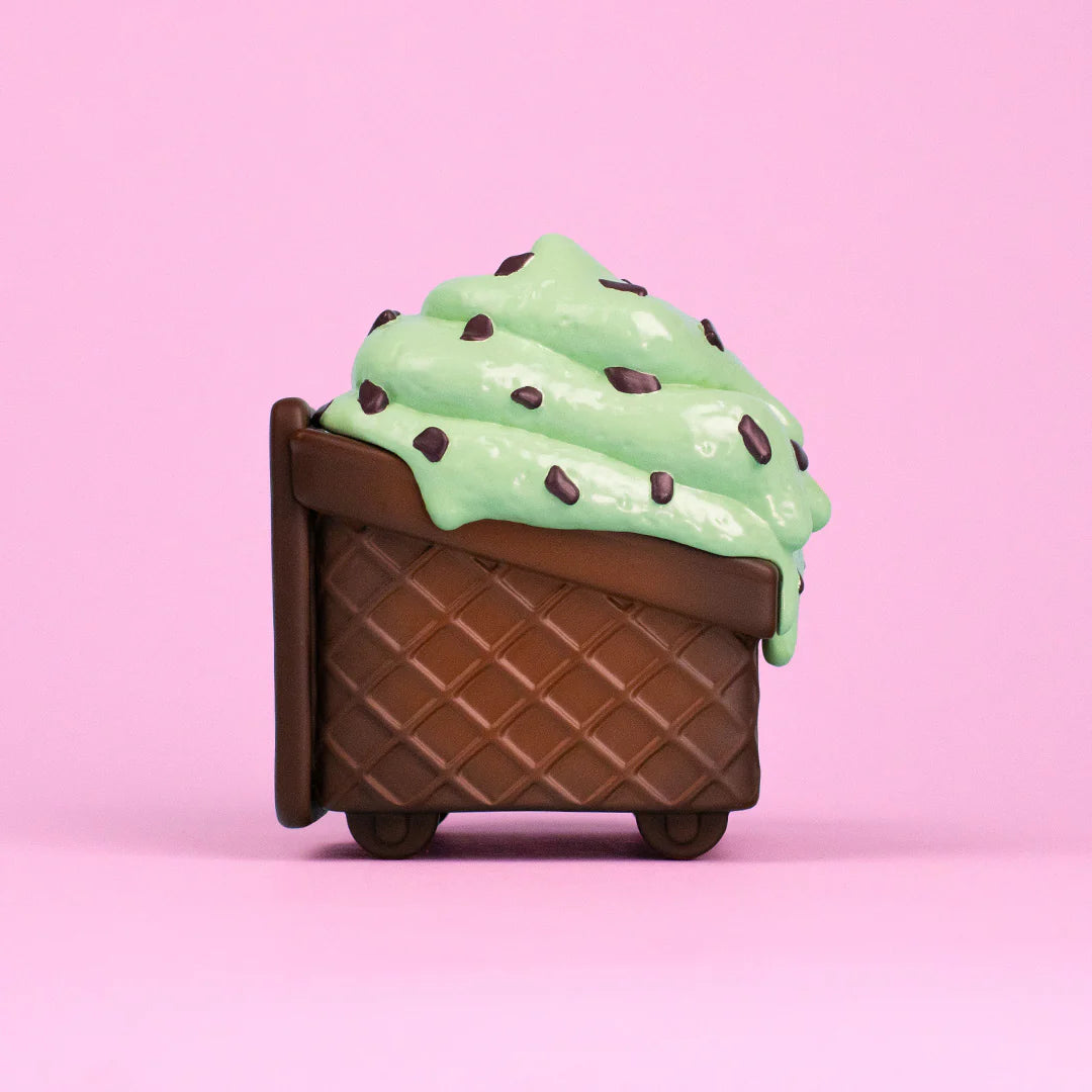 Side view of waffle cone Dumpster Fire figure topped with mint chip melting ice cream.