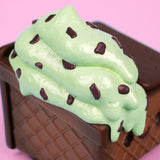 Close-up of mint chip ice cream scoops with chocolate chips on Dumpster Fire figure.