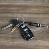 Misfits guitar plug keychain with keys on wooden surface