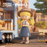 Molinta coffee break figure standing beside a coffee truck with a hot drink