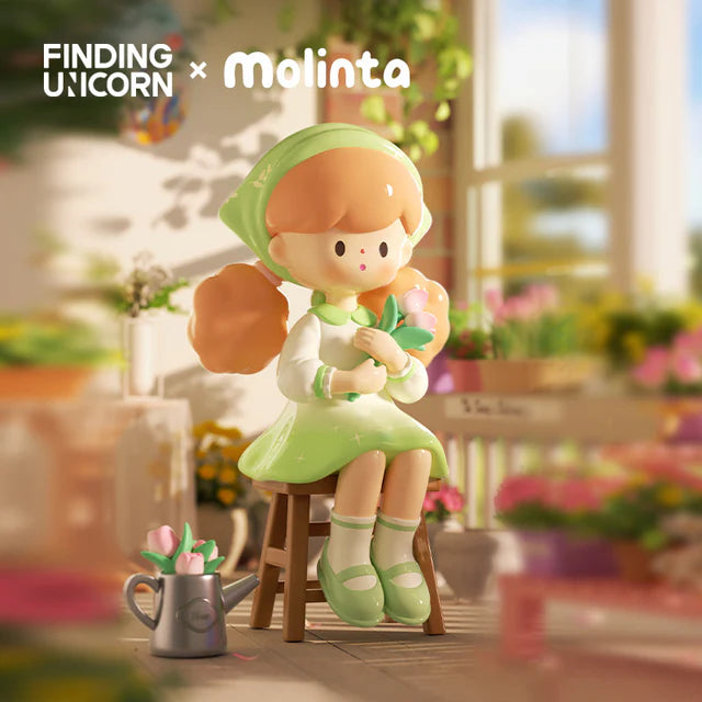 Molinta gardening figure sitting with flowers in a bright garden setting