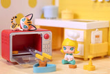 Molly figure in a chef hat sitting next to a red oven with cat figure on top, miniature kitchen props