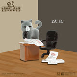 Cat supervisor reviewing paperwork with a suspicious expression behind an office desk