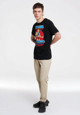 Full-body view of man styling He-Man Masters of the Universe black T-shirt with jeans