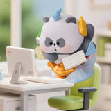 Mr. PA multitasking office worker figure balancing work supplies at a computer desk