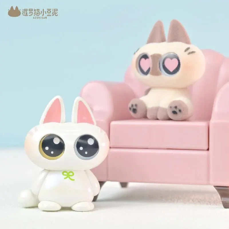 Nobeko Moe Azukisan mini bean cat figure standing beside a pink sofa with a heart-eyed Azukisan figure