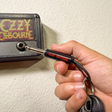 Ozzy Osbourne guitar plug keychain plugged into Jack Rack holder