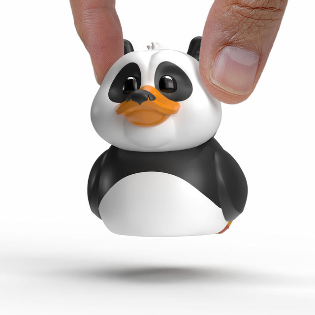 Mini TUBBZ Po from Kung Fu Panda being held between fingers, close-up view