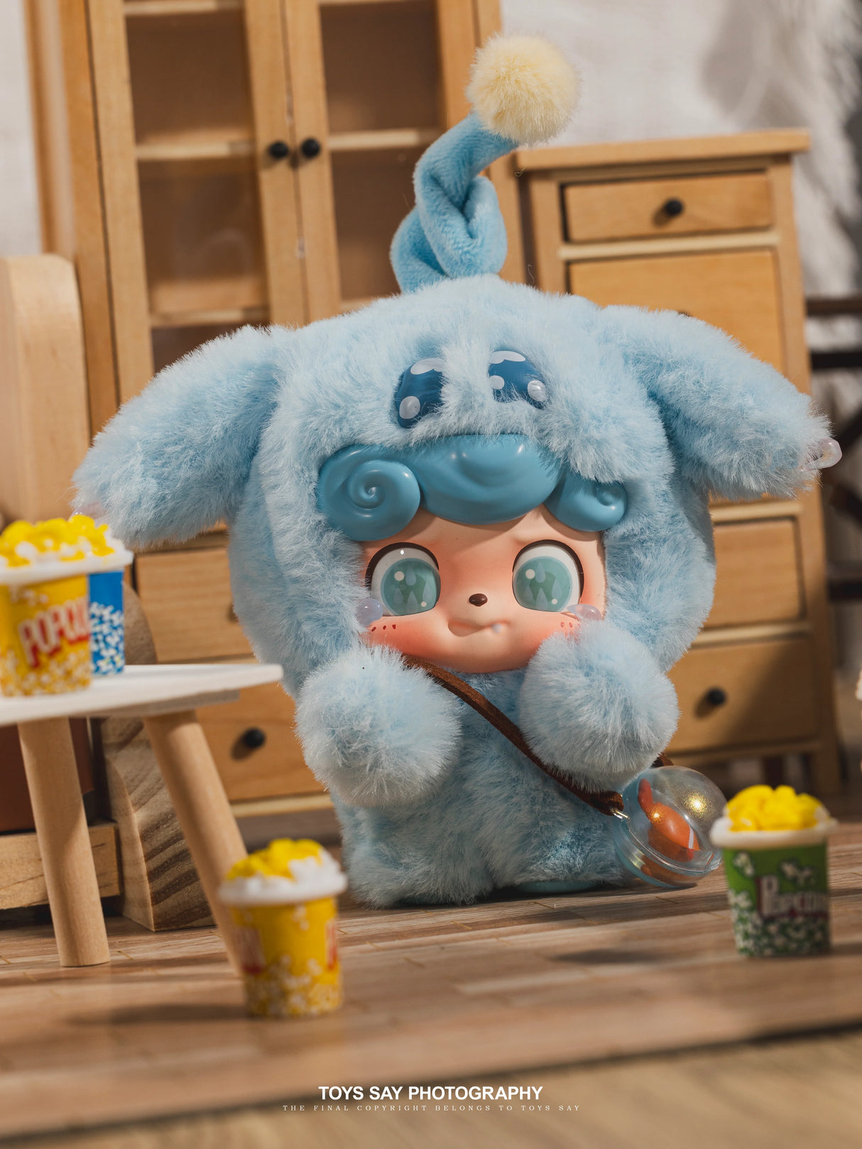 Q Kid Emotional Hairy Monsters blue Sadness character holding popcorn accessory