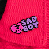sad boy enamel pin attached to red fabric aesthetic enamel pin