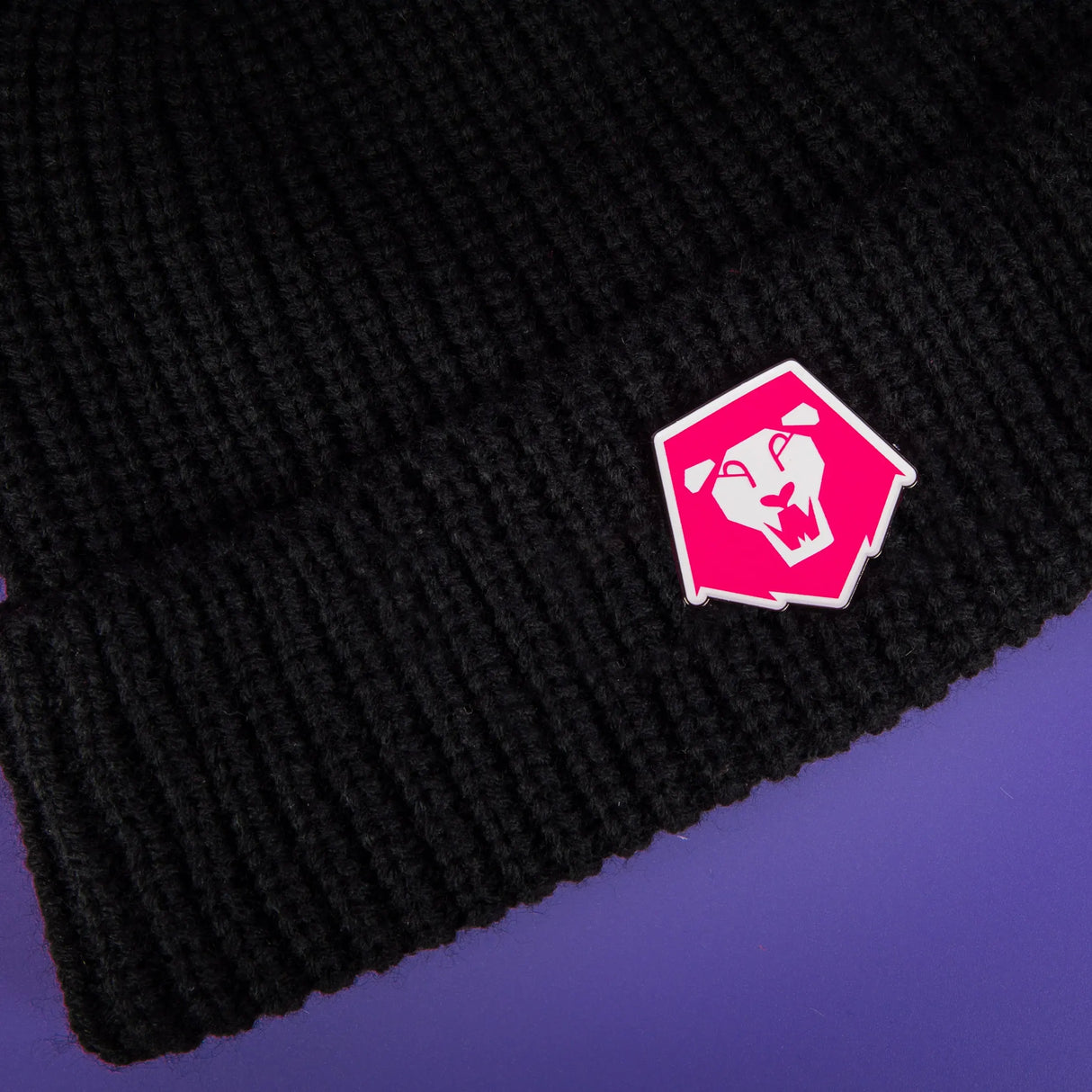 Saja Boys logo pin attached to black beanie