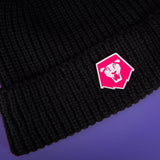 Saja Boys logo pin attached to black beanie