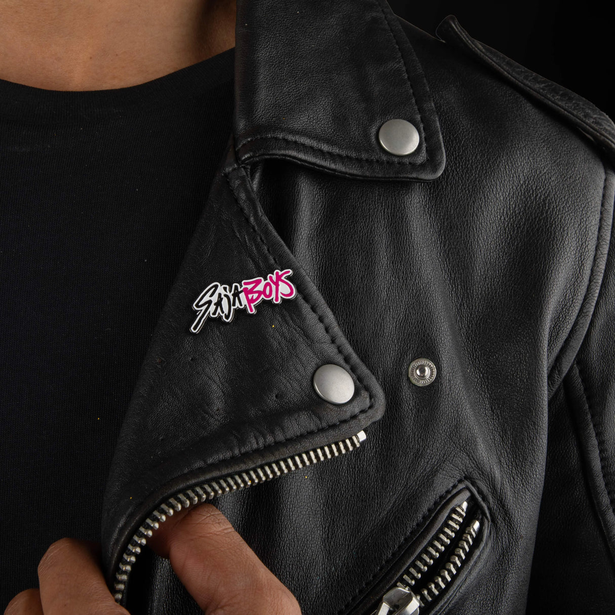 Saja Boys pin worn on black leather jacket