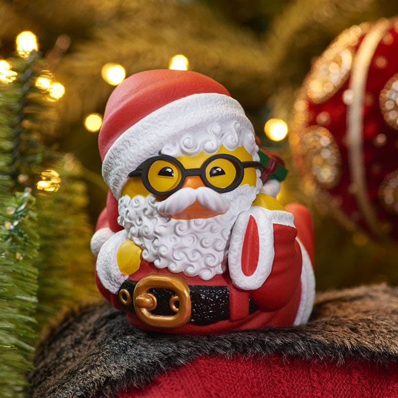 Santa Claus TUBBZ collectible duck figure lying in classic red suit with white beard and glasses.