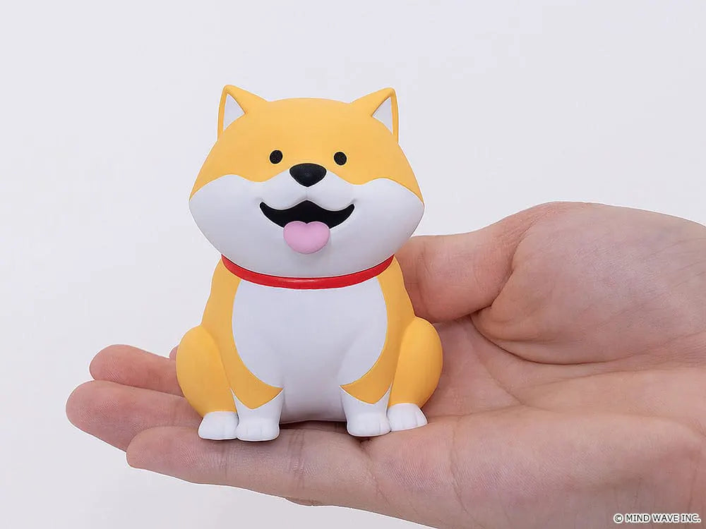 Shibanban yellow Shiba Inu soft vinyl figure displayed in the palm of a hand.
