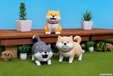 Three Shibanban soft vinyl figures posed in a miniature garden display.