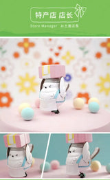 Shimaenaga Sayuri Store Manager vinyl figure carrying pink gift box on head.