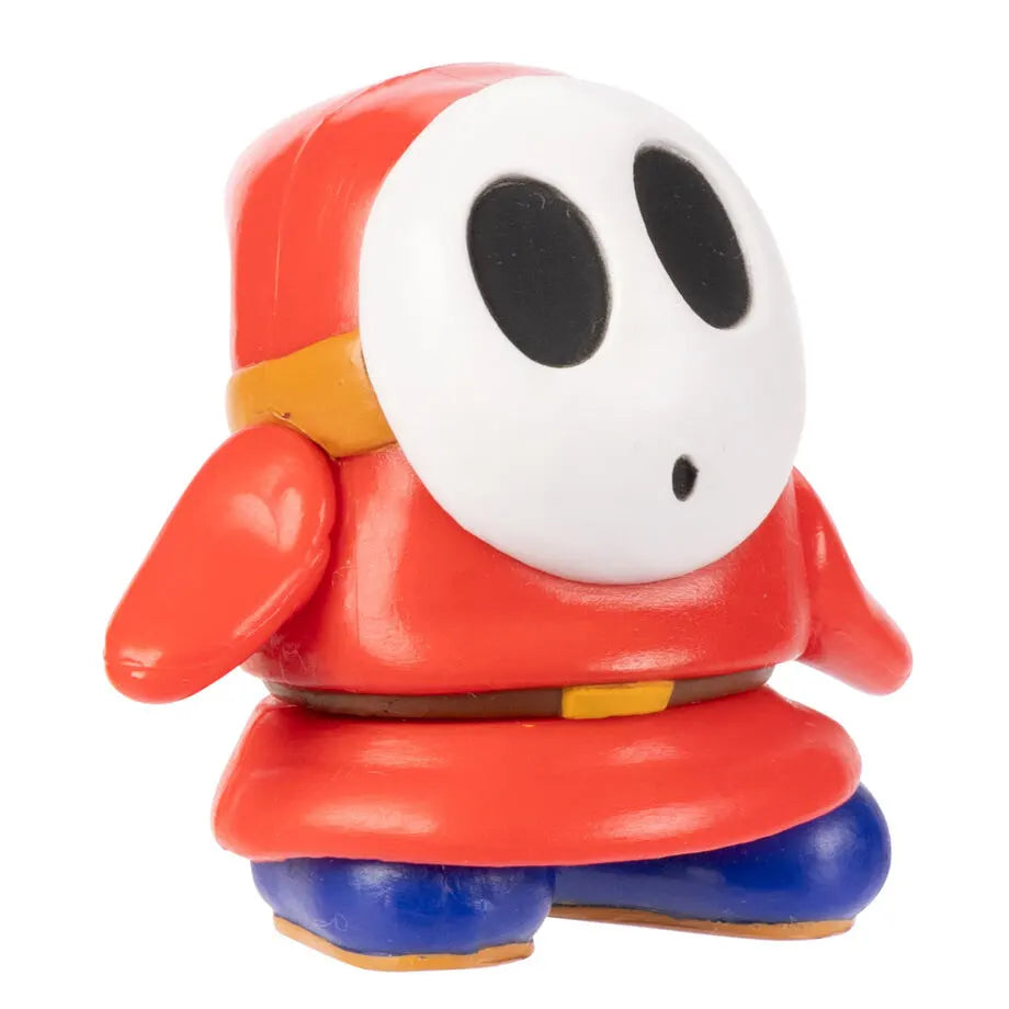 Shy Guy action figure 6,5 cm side angle showing red outfit and blue shoes from Super Mario series.