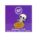 Skull Surfer enamel pin on branded backing card with skeleton surfing a coffin