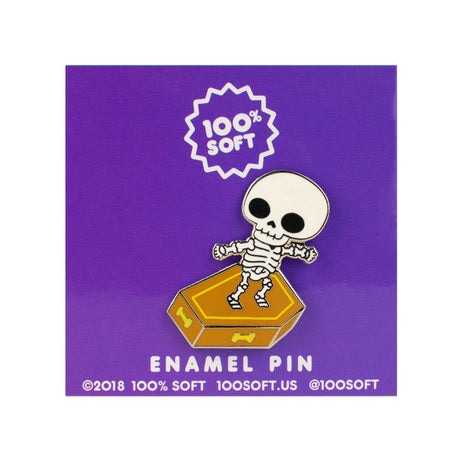 Skull Surfer enamel pin on branded backing card with skeleton surfing a coffin
