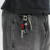 Slayer plug keychain attached to keys in pocket