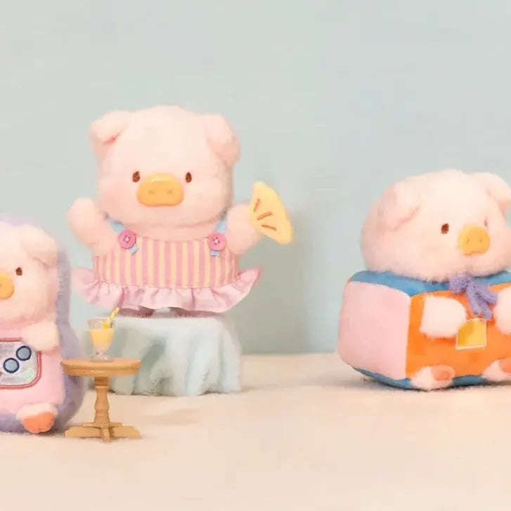 LuLu The Piggy plush wearing a striped dress alongside a cube-shaped playhouse character