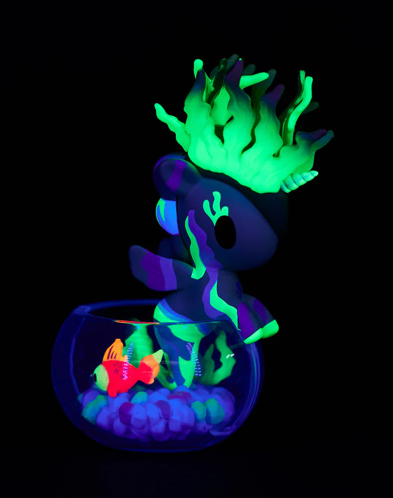 Tokidoki Mermicorno Neon Reef figure Sunshine Coral glowing under UV light with neon coral base inside a bowl.