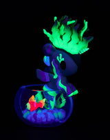 Tokidoki Mermicorno Neon Reef figure Sunshine Coral glowing under UV light with neon coral base inside a bowl.