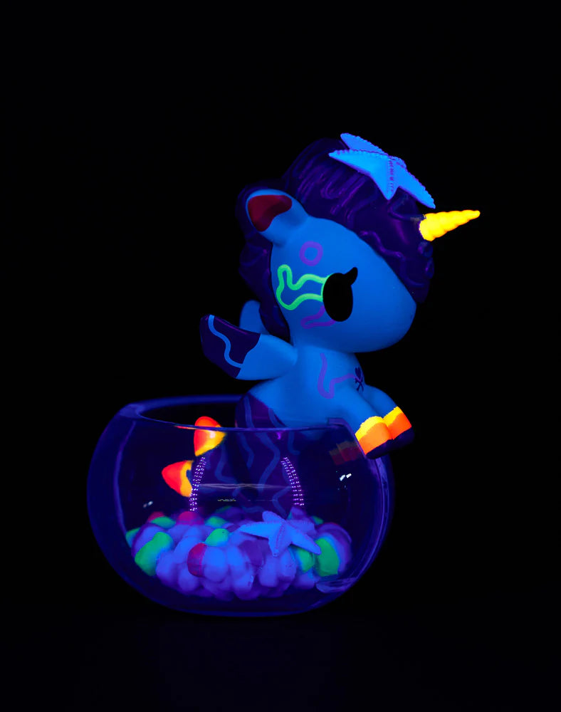 Tokidoki Mermicorno Neon Reef figure Neon Green Coral with purple coral mane glowing under blacklight in a bowl display.