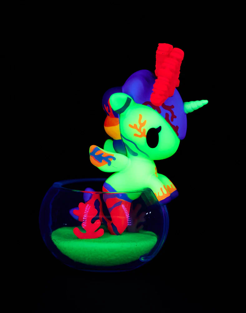 Tokidoki Mermicorno Neon Reef figure Pink Elk Coral glowing in purple and red under blacklight with coral base.