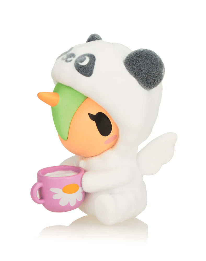Cozy Unicorno tokidoki figure in panda pajamas holding a mug