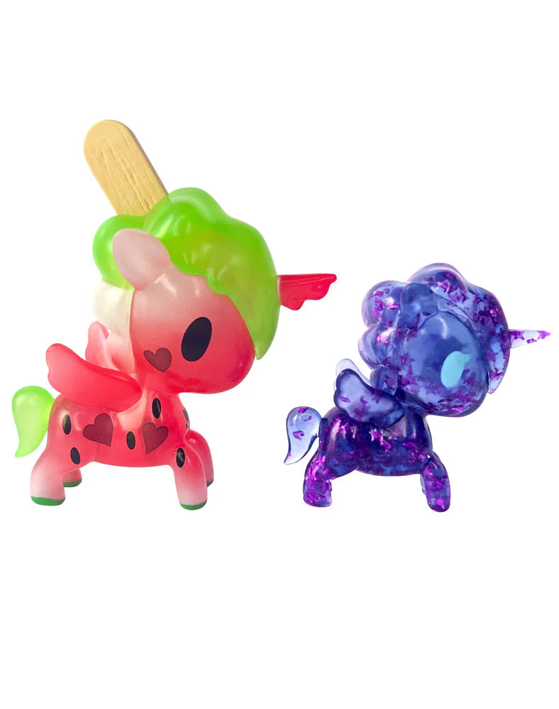 Two Unicorno Lite Shimmer Glitter figures side by side, watermelon and purple glitter edition