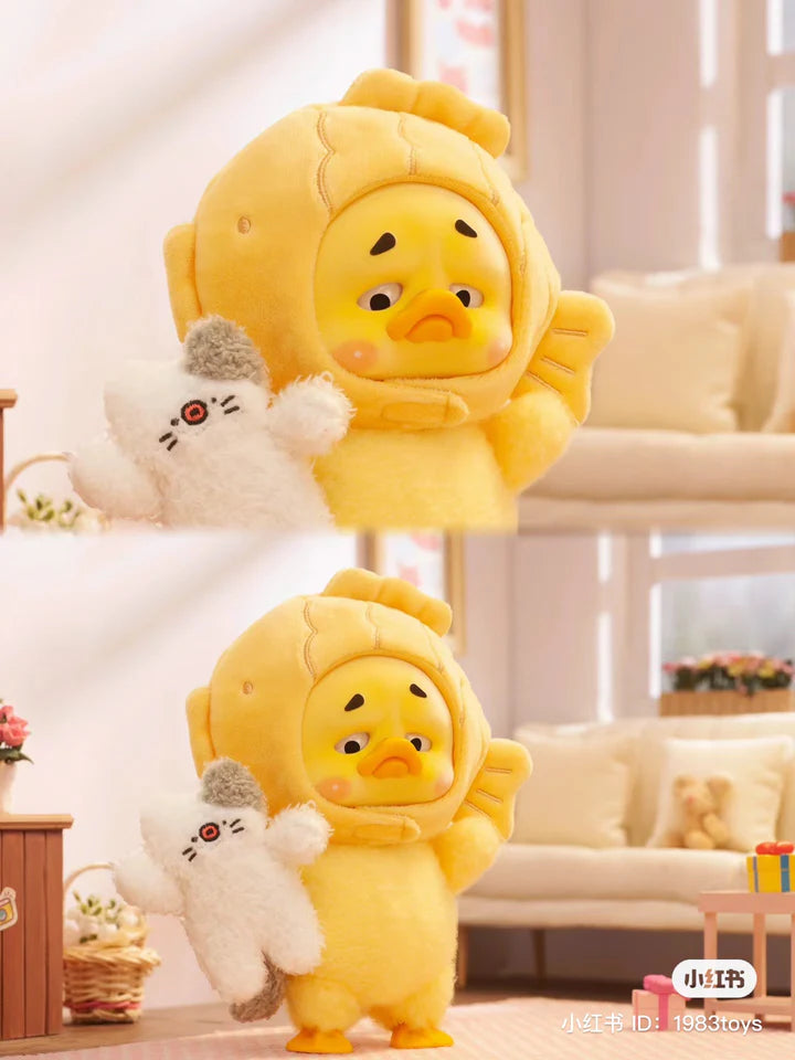 Upset Duck fish costume edition holding a plush toy cat