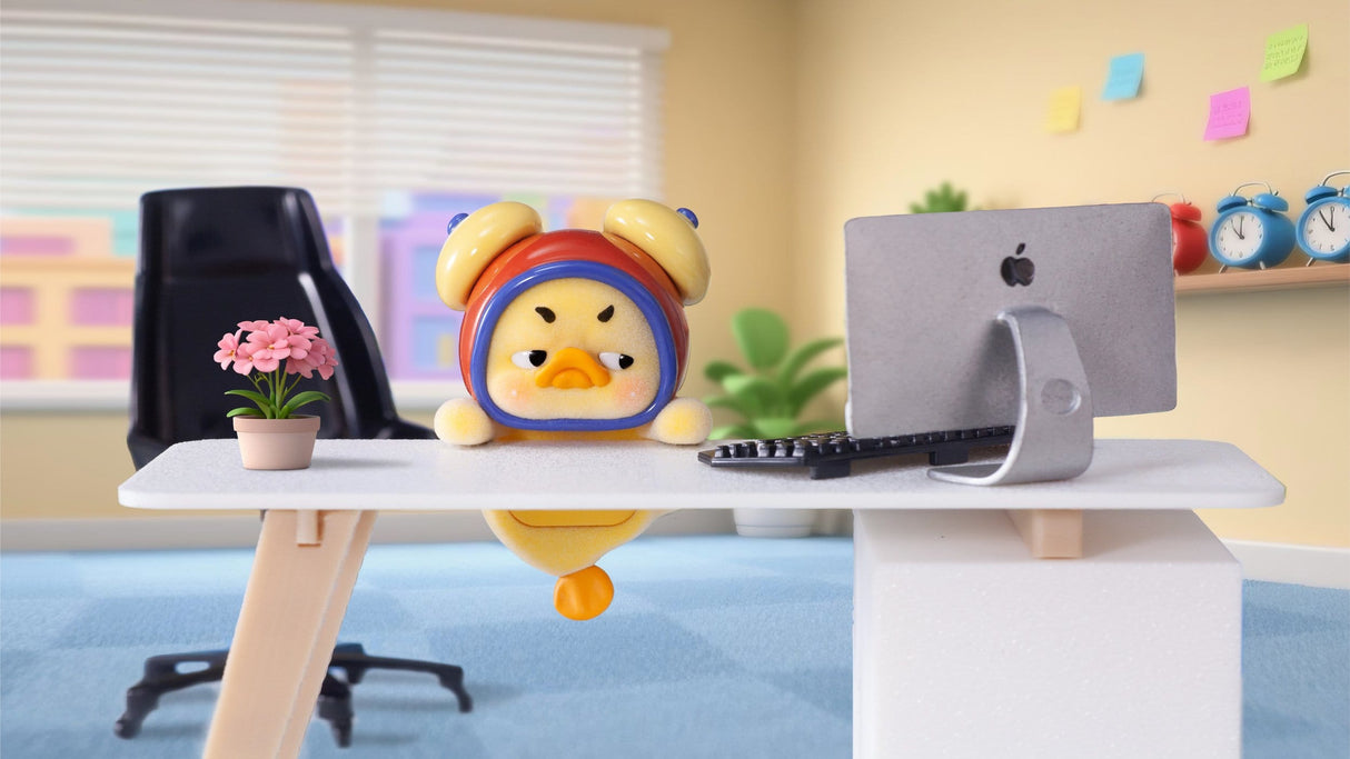 Upset Duck Status Display Duck vinyl figure at desk setup with computer display