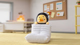 Upset Duck relaxed mood vinyl figure lounging on floor cushion with office background