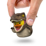 Close-up of Velociraptor Mini TUBBZ being held between fingers