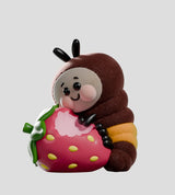 Wooly Bear fuzzy caterpillar figure hugging a strawberry collectible